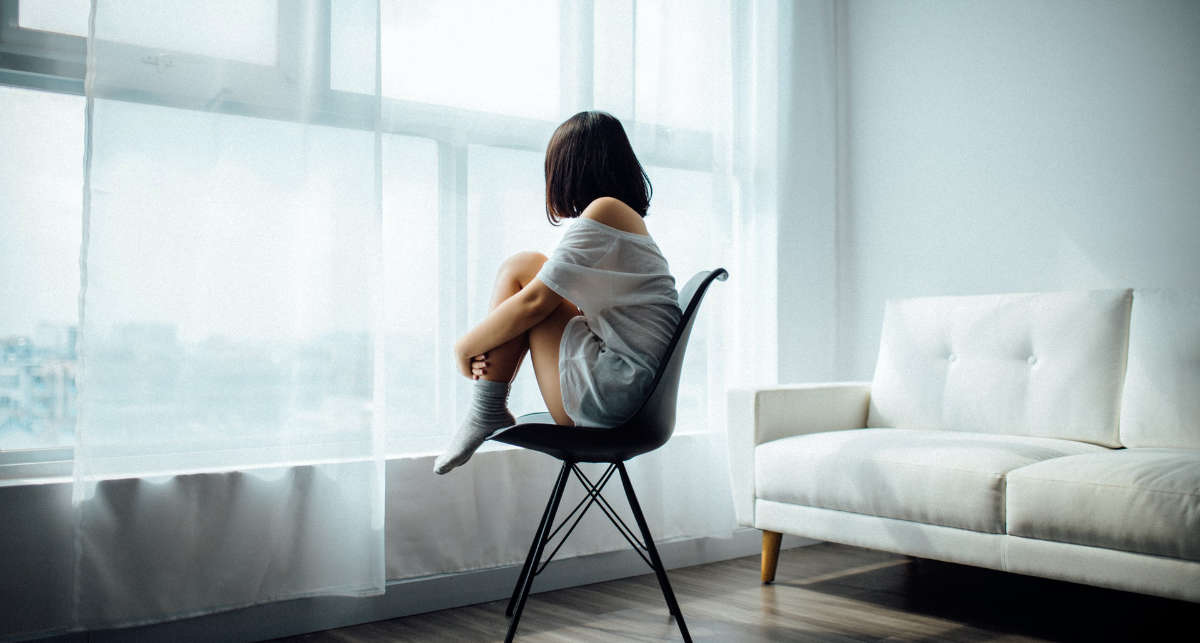 woman alone in a room thinking about her loneliness